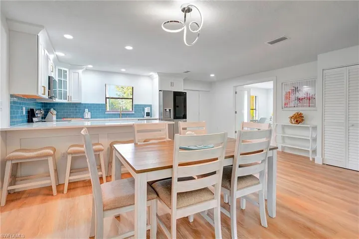 Dining space with sink and light hardwood / wood-style floors