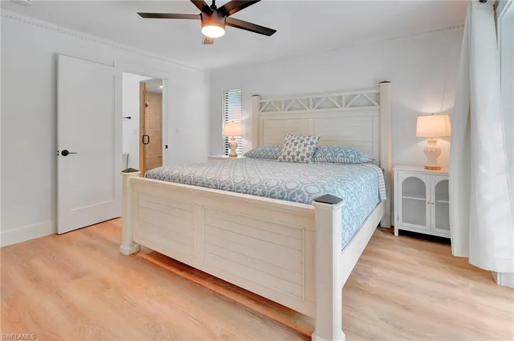 Bedroom with ceiling fan, light hardwood / wood-style flooring, and crown molding