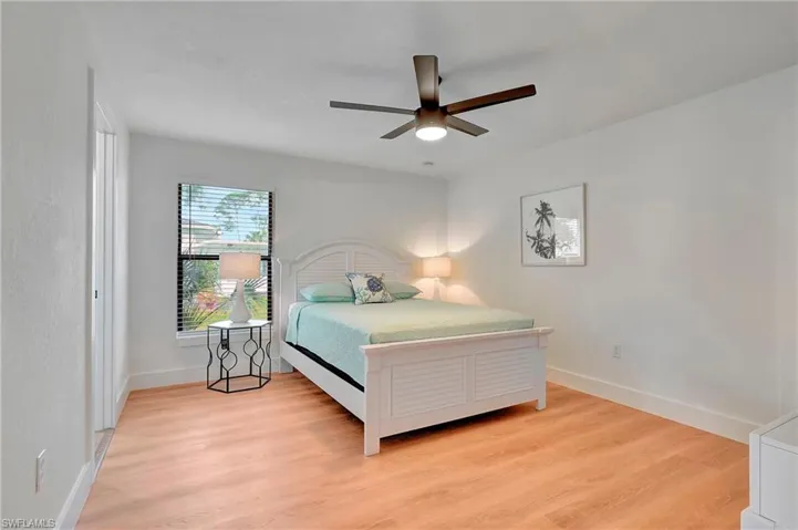 Bedroom with ceiling fan and light hardwood / wood-style flooring