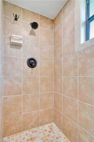 Bathroom featuring tiled shower