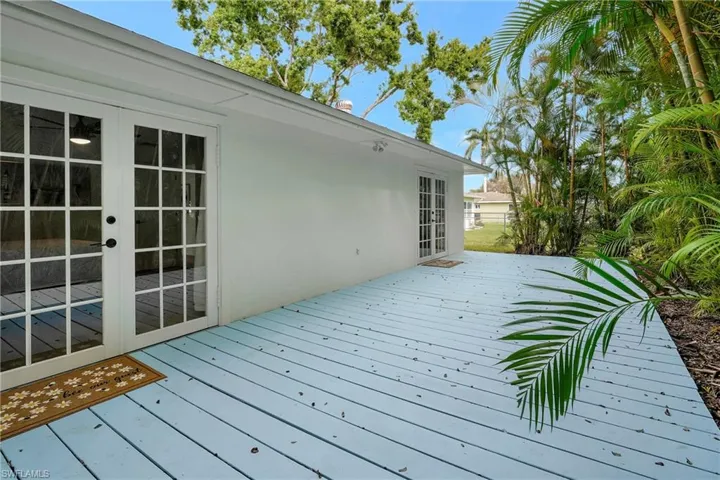 Wooden terrace featuring french doors