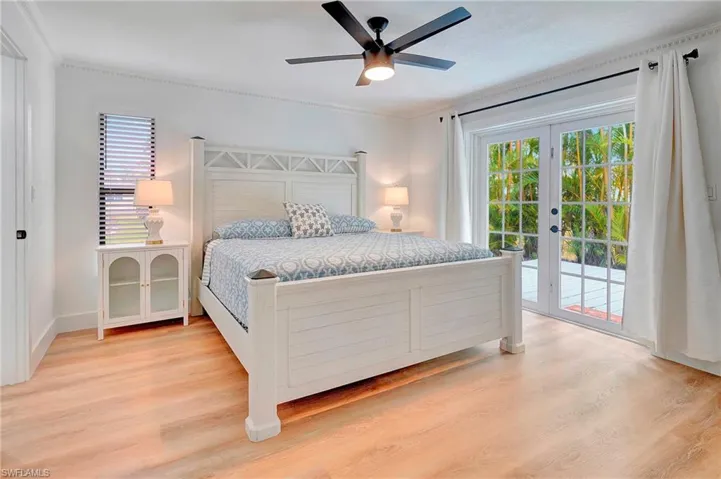 Bedroom with ceiling fan, multiple windows, light hardwood / wood-style flooring, and access to outside