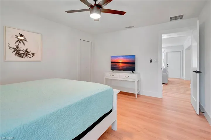 Bedroom with ceiling fan and light hardwood / wood-style flooring