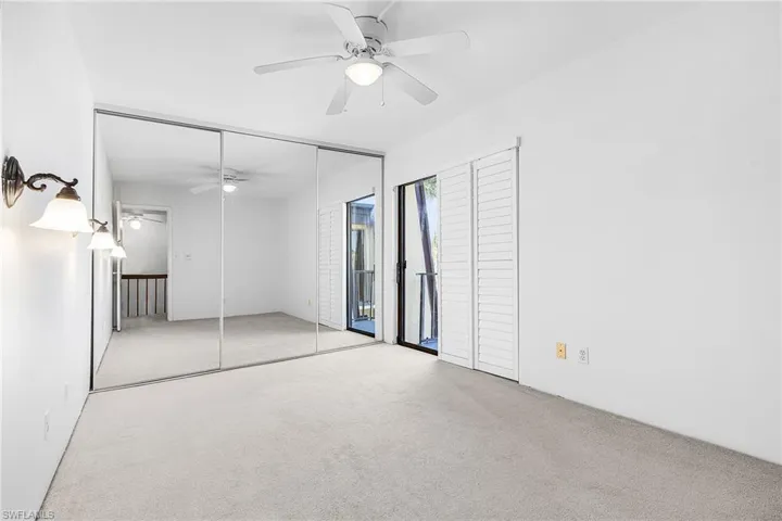 2nd bedroom w/mirrored closet doors, plantation shutter covers the sliding doors.