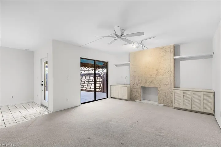 Hurricane rated full glass front door, sliding doors, a peek out to the patio and the faux stone finished 'fireplace'. Built in storage w/louvered doors.