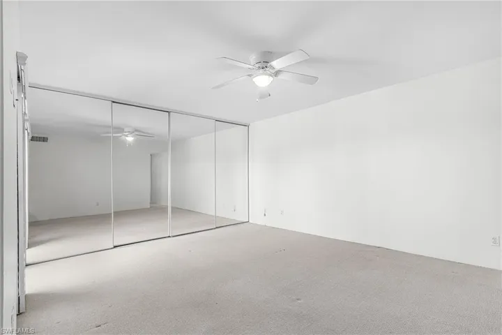 Master Bedroom w/mirrored closet doors.