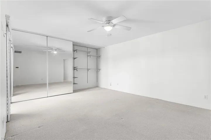 Master Bedroom has quad mirrored sliding doors - these are halfway open to show the ample storage behind .
