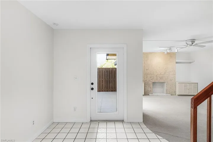 From the base of the stairs toward the front door.