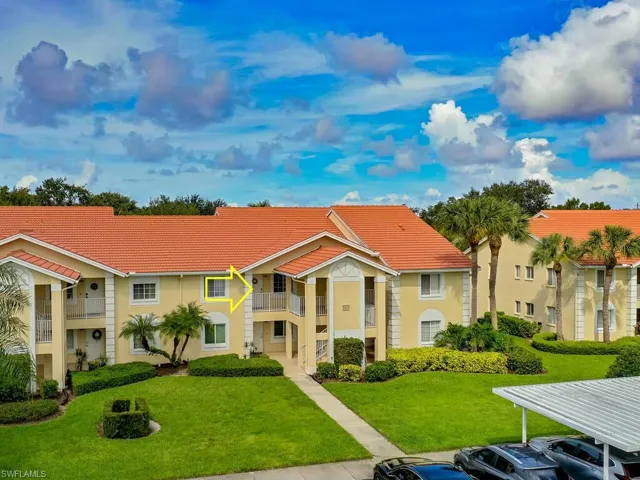 View of front of house with a balcony and a front yard