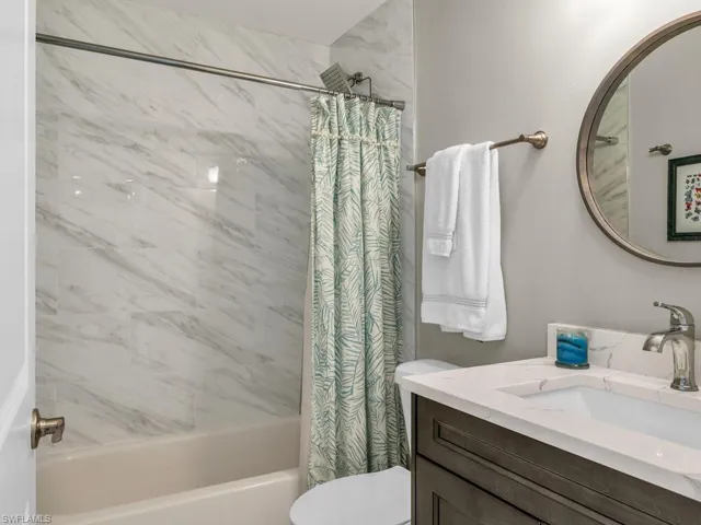 Full bathroom with vanity, toilet, and shower / tub combo with curtain