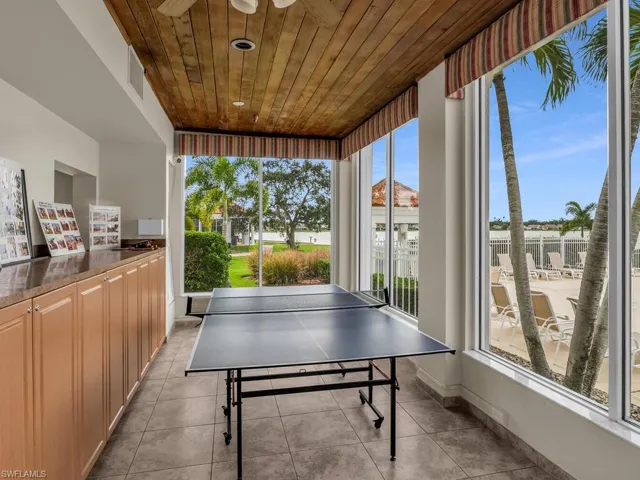 Playroom featuring wooden ceiling, light tile patterned floors, and ceiling fan