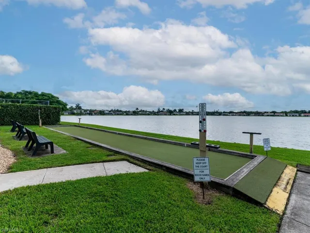View of dock featuring a water view and a yard