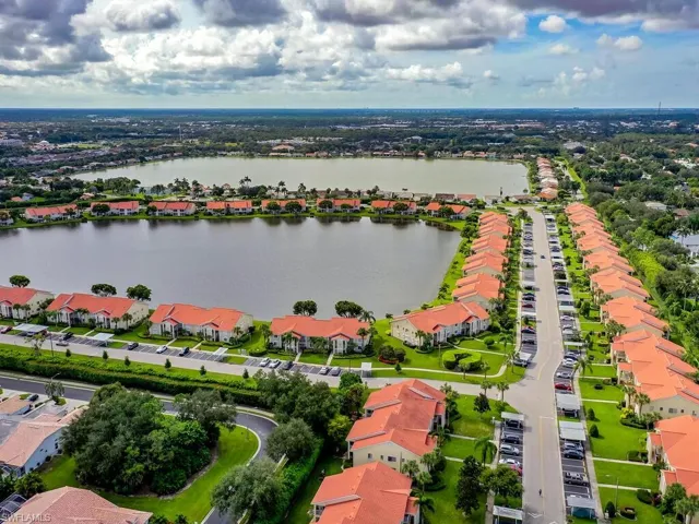 Birds eye view of property with a water view