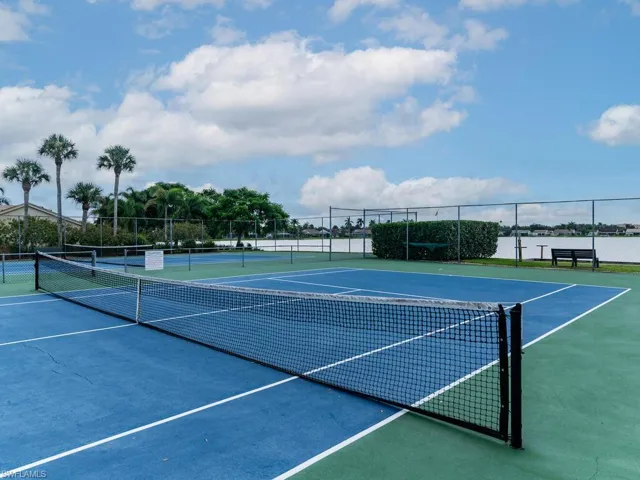 View of sport court featuring a water view