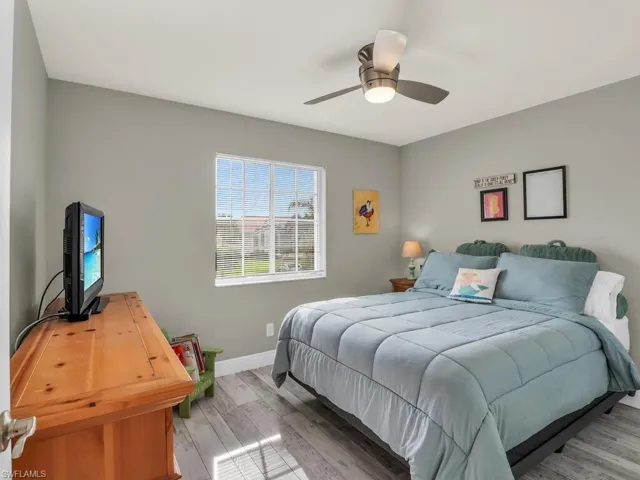 Bedroom with ceiling fan and light hardwood / wood-style flooring