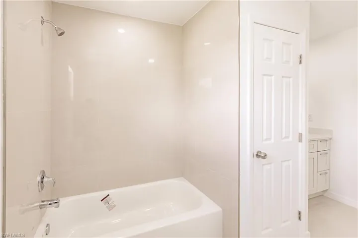 Bathroom with vanity and tiled shower / bath combo