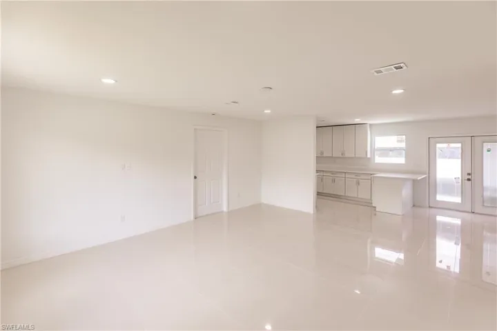 Spare room with light tile patterned floors and french doors