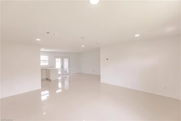 Tiled empty room with french doors