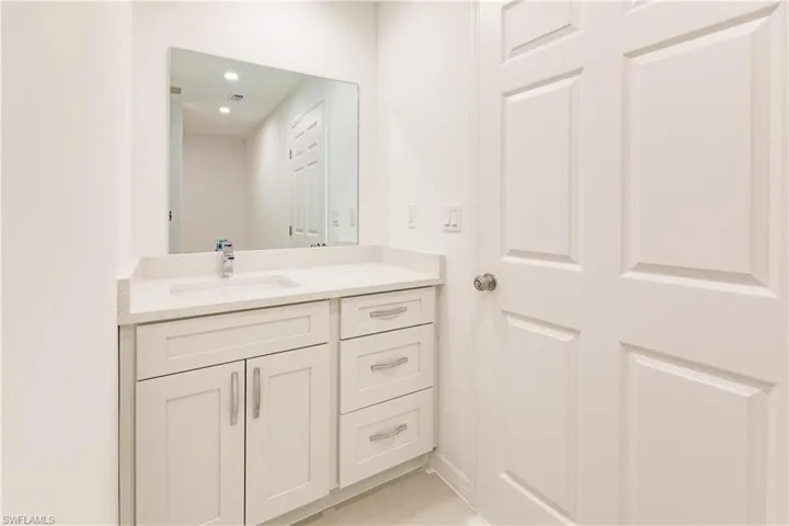 Bathroom featuring tile patterned floors and vanity
