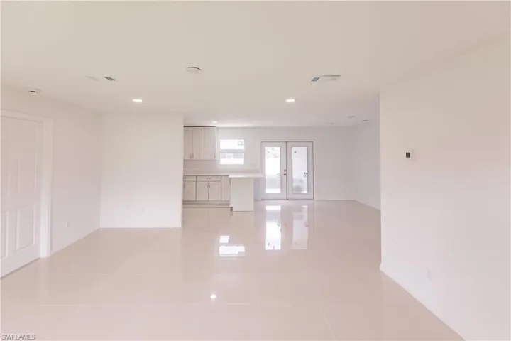 Spare room with light tile patterned floors and french doors
