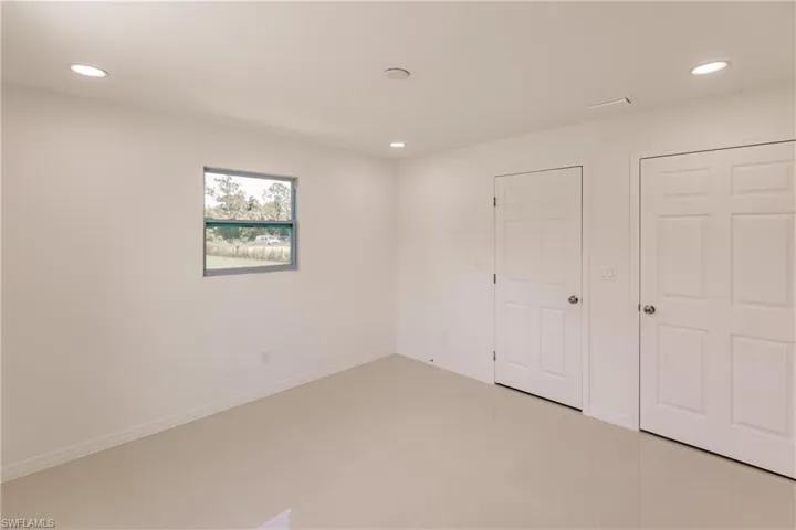 Unfurnished bedroom with light tile patterned floors