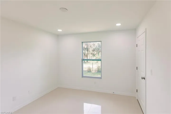 Unfurnished room featuring light tile patterned flooring