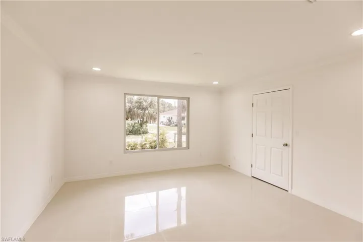 Spare room with light tile patterned floors and ornamental molding