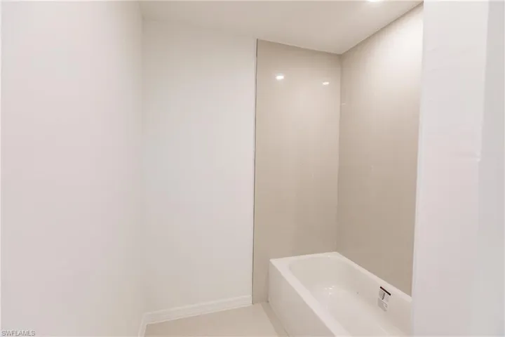 Bathroom featuring plus walk in shower and tile patterned floors