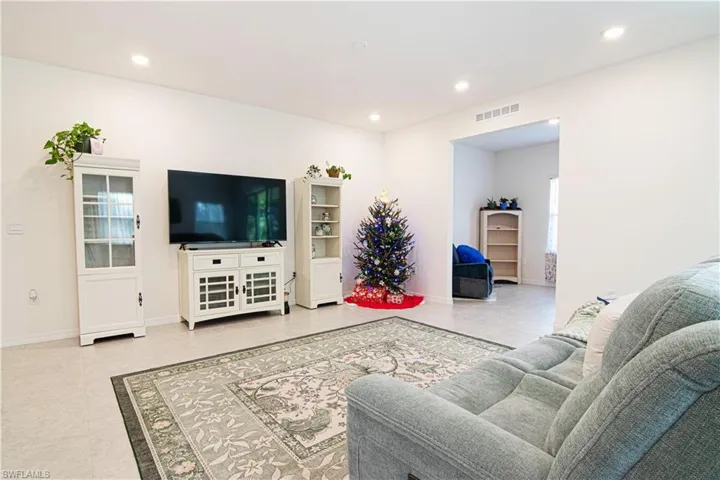 Living area featuring recessed lighting and light tile patterned floors