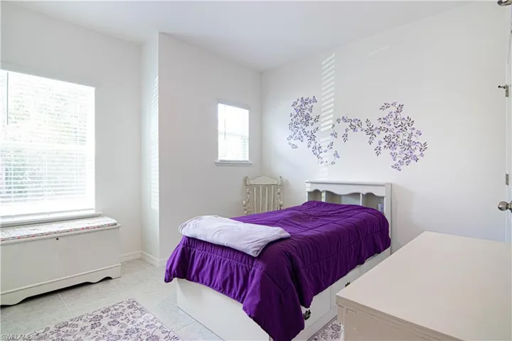 Bedroom with light tile patterned flooring