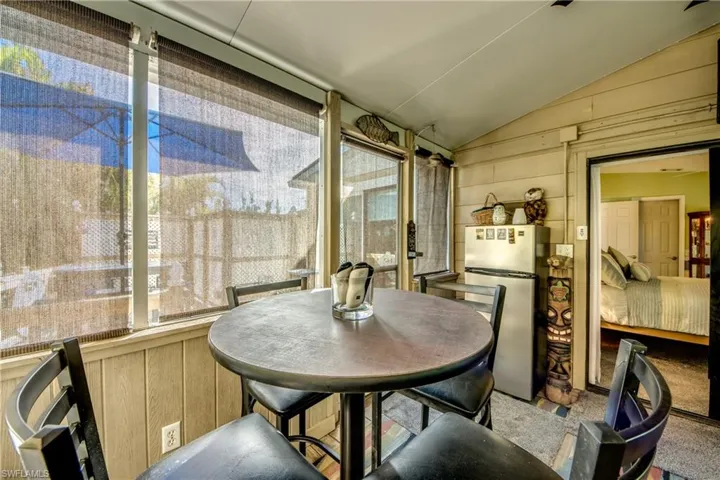 Sunroom featuring a healthy amount of sunlight and vaulted ceiling