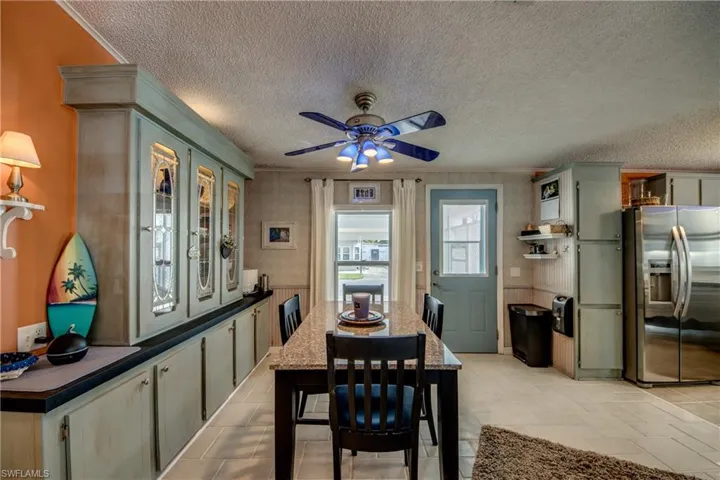 Dining area with ceiling fan and a textured ceiling