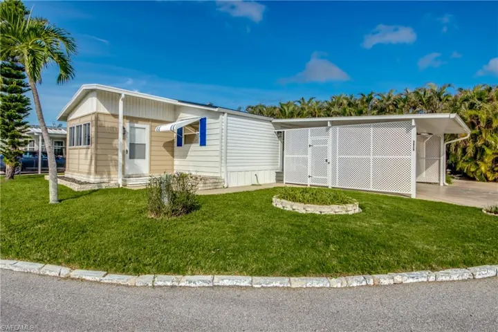 View of front of house featuring a front yard and a carport