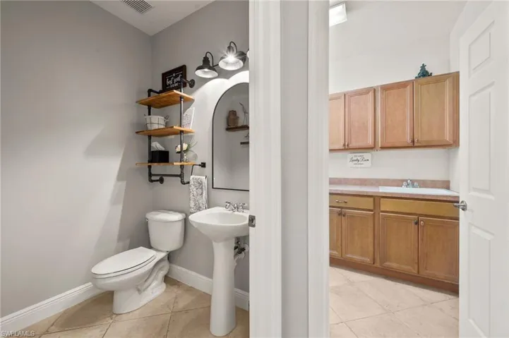 Bathroom featuring tile patterned floors, sink, and toilet