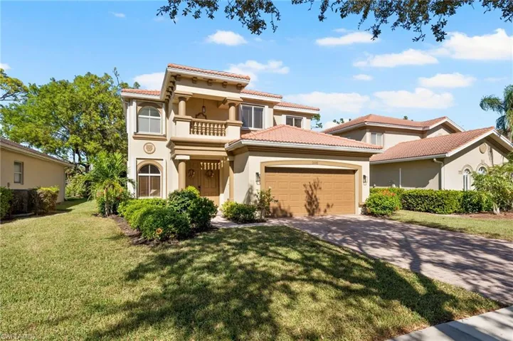 Mediterranean / spanish-style house with a balcony and a front lawn