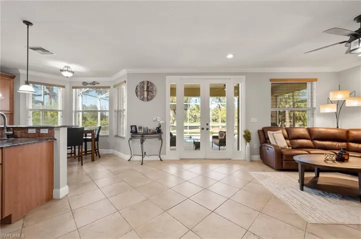 Living room featuring crown molding and plenty of natural light