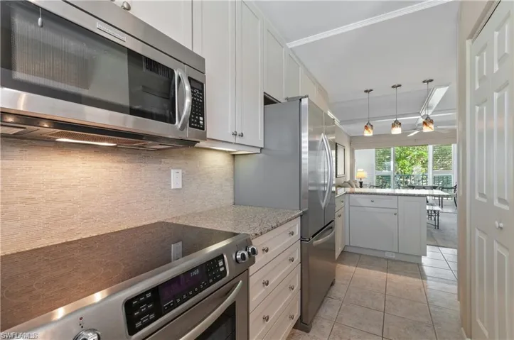 Updated Kitchen with stainless appliances, stone work back splash and granite countertops