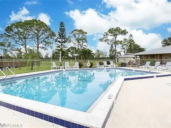 Community pool featuring a patio