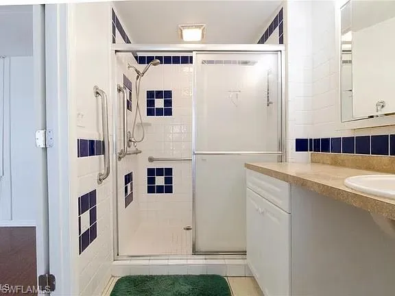 Bathroom featuring vanity and a shower stall