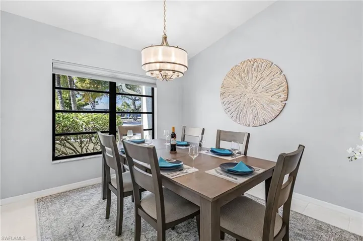 Dining room with vaulted ceiling and a chandelier