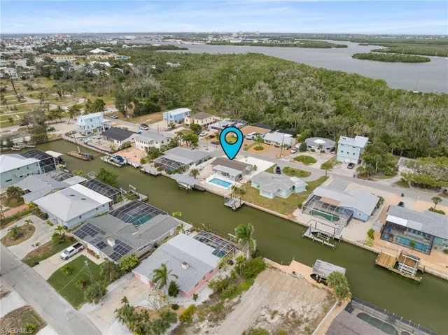 Living area featuring light floors, ceiling fan, and wooden walls