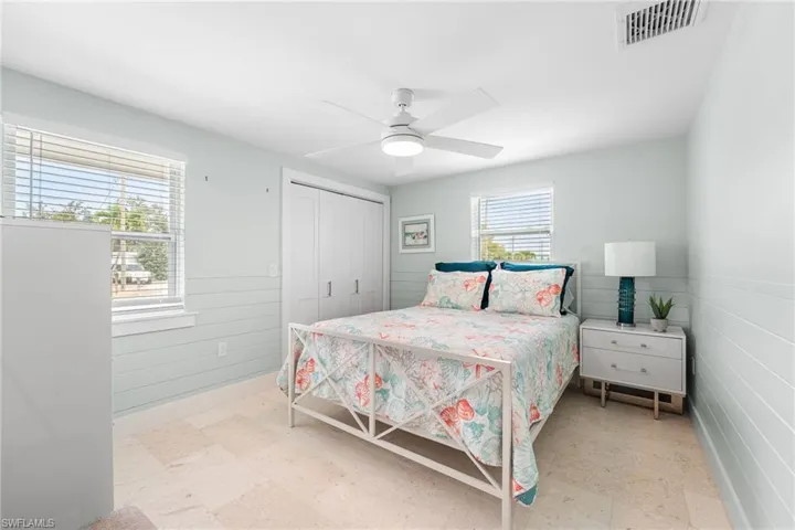 Guest Bedroom with wainscoting and light tile patterned floors.  Room to sleep 4 in this bedroom