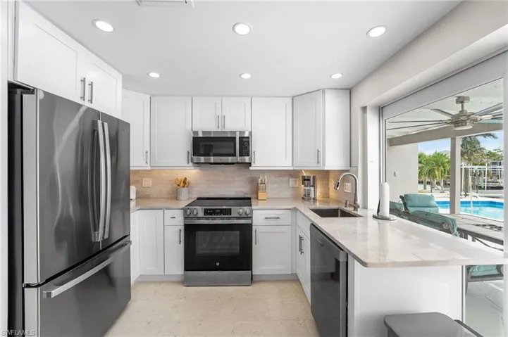 Dining area featuring a wainscoted wall, recessed lighting