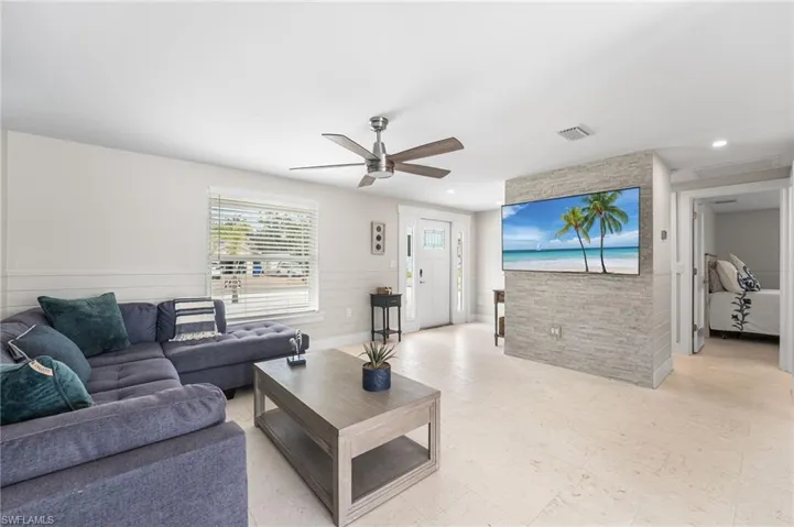 Kitchen featuring plenty of natural light, stainless steel dishwasher, backsplash, white cabinets, and recessed lighting