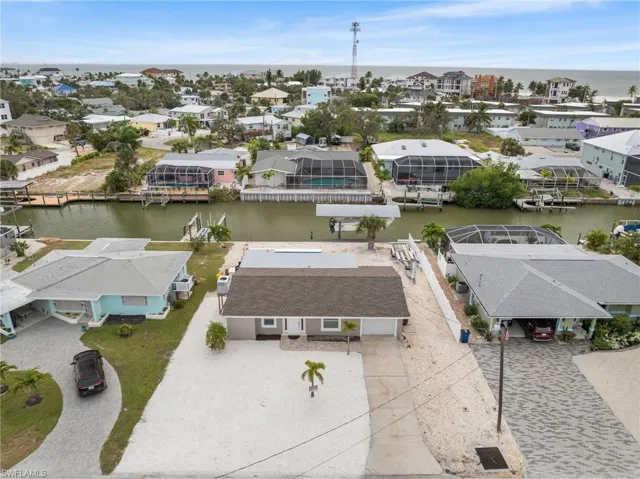Ranch-style home with concrete driveway, an attached garage, a shingled roof, and stucco siding