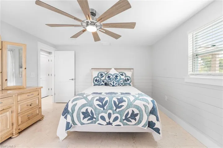 Bathroom featuring a closet, connected bathroom, walk in shower, a ceiling fan, and light tile patterned flooring