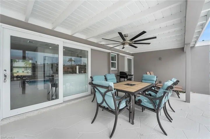 View of patio / terrace with outdoor dining area, ceiling fan, and a grill