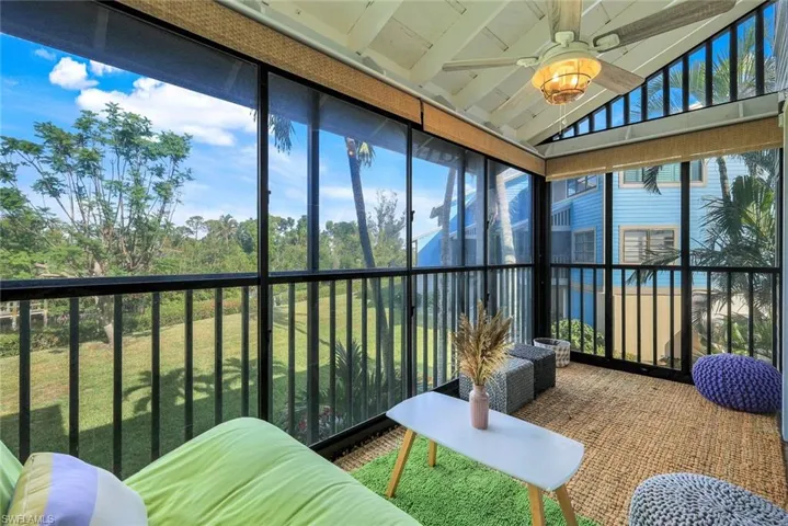 Sunroom featuring ceiling fan and lofted ceiling