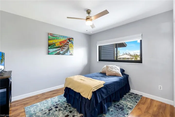 Bedroom featuring wood-type flooring and ceiling fan