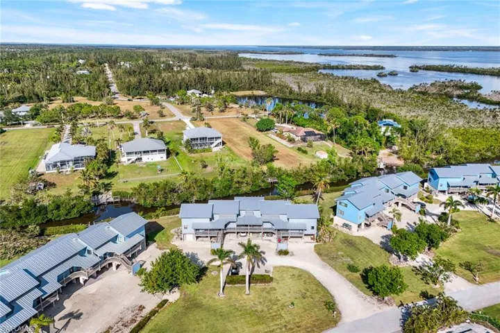 Birds eye view of property with a water view